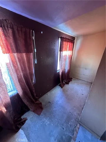 a view of an empty room with windows