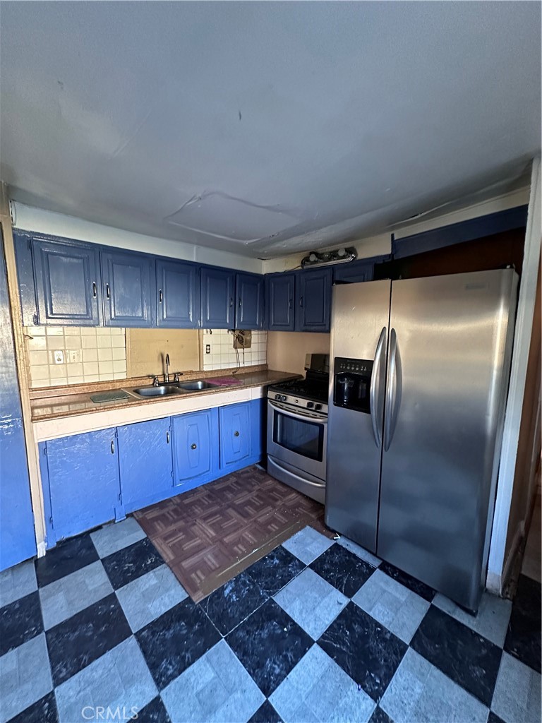 258 West 7th Street, Unit 51 San Jacinto, CA 92583 - Photo 9 of 14 a kitchen with stainless steel appliances granite countertop a refrigerator sink and cabinets