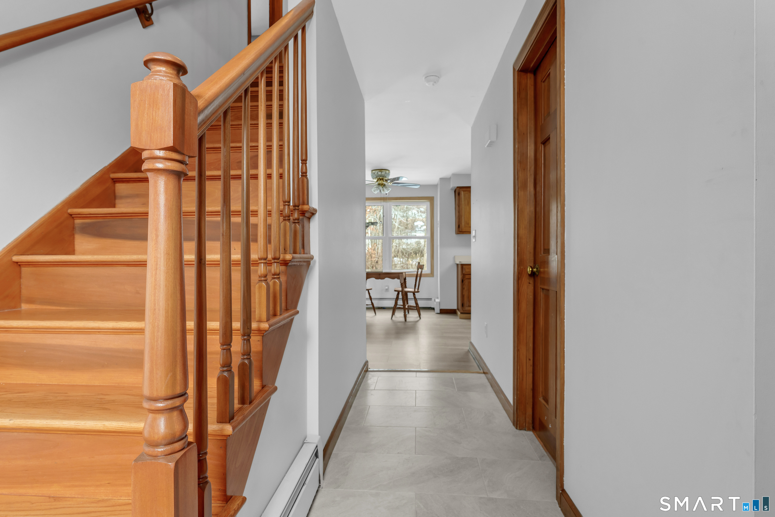 26 Pent Road Branford, CT 06405 - Photo 11 of 28 a view of a hallway with wooden floor and staircase