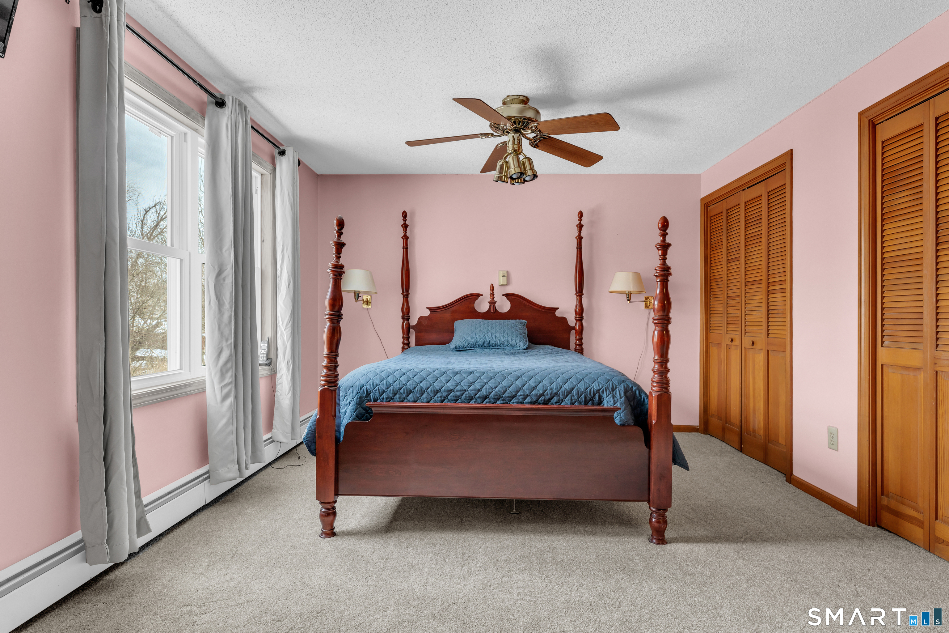 26 Pent Road Branford, CT 06405 - Photo 14 of 28 a bedroom with a bed and a chandelier
