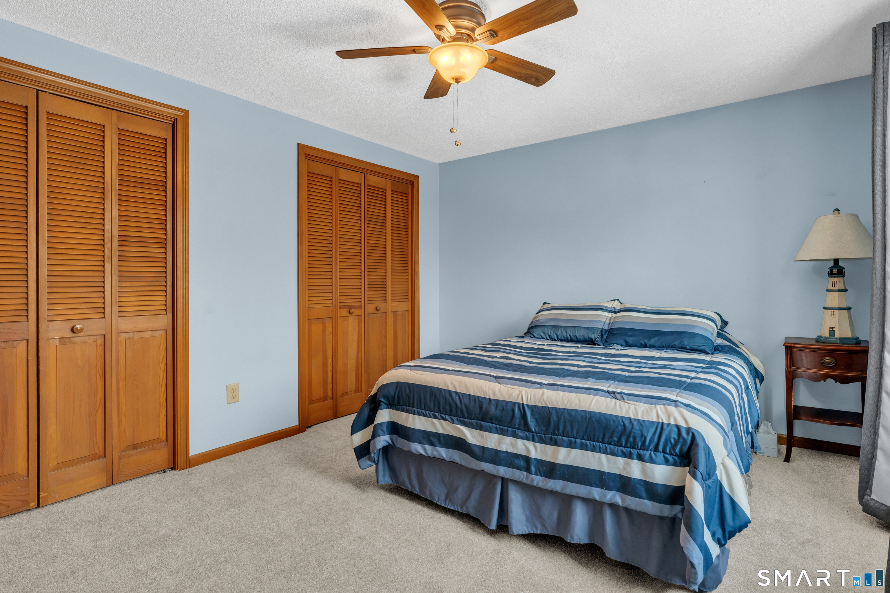 26 Pent Road Branford, CT 06405 - Photo 18 of 28 a bedroom with a bed and a chandelier