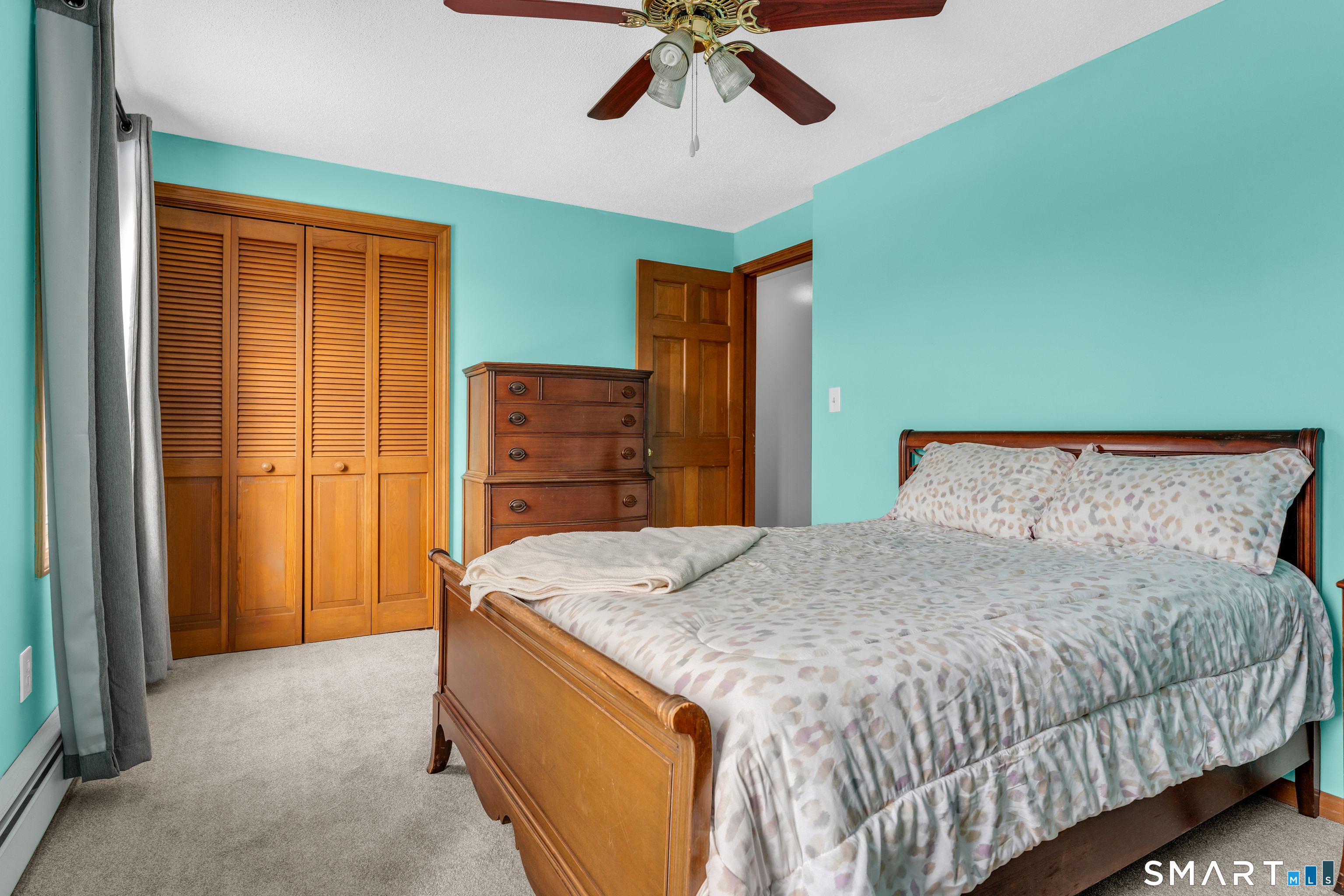 26 Pent Road Branford, CT 06405 - Photo 19 of 28 a spacious bedroom with a bed and a chandelier