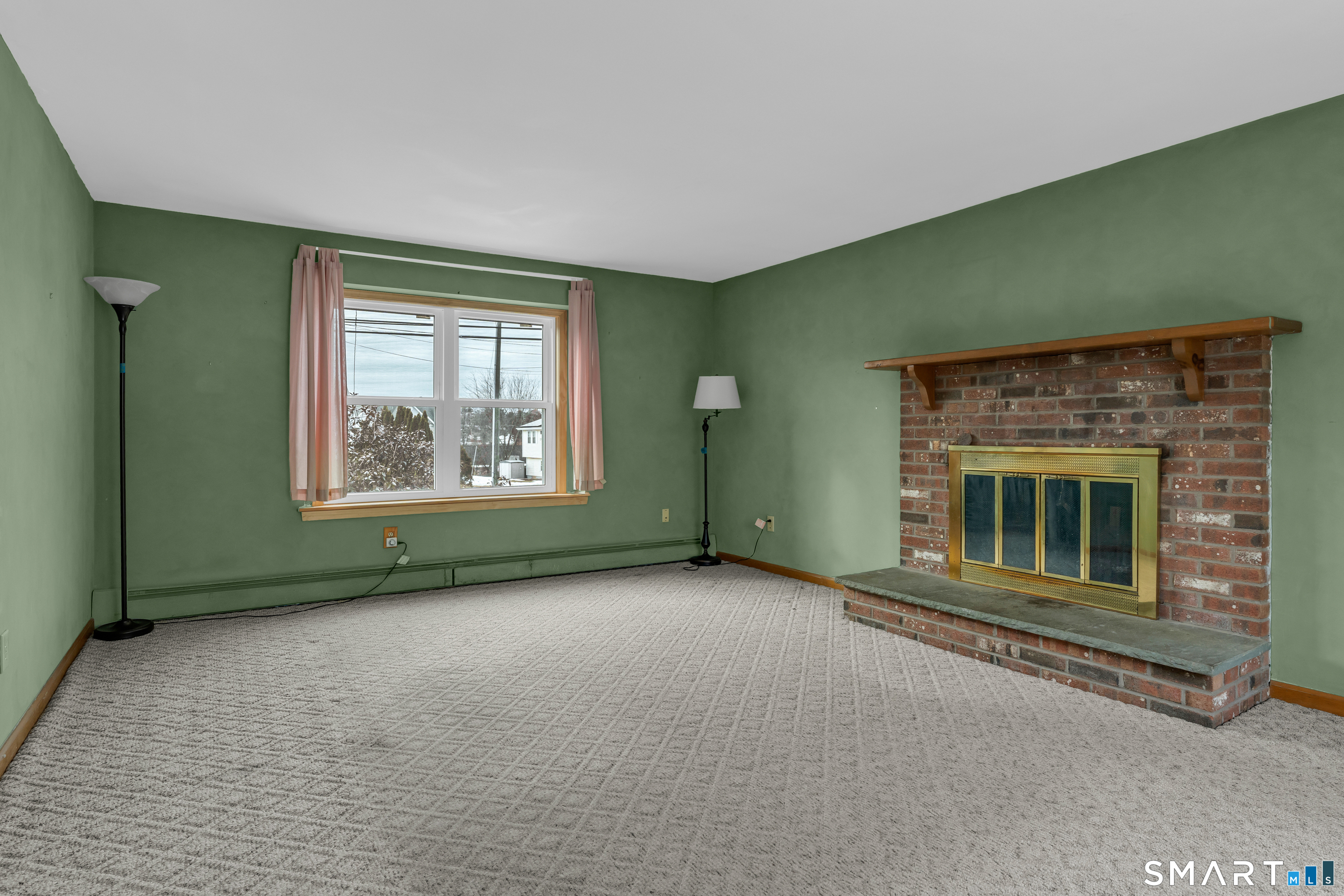 26 Pent Road Branford, CT 06405 - Photo 7 of 28 an empty room with a fireplace and a window