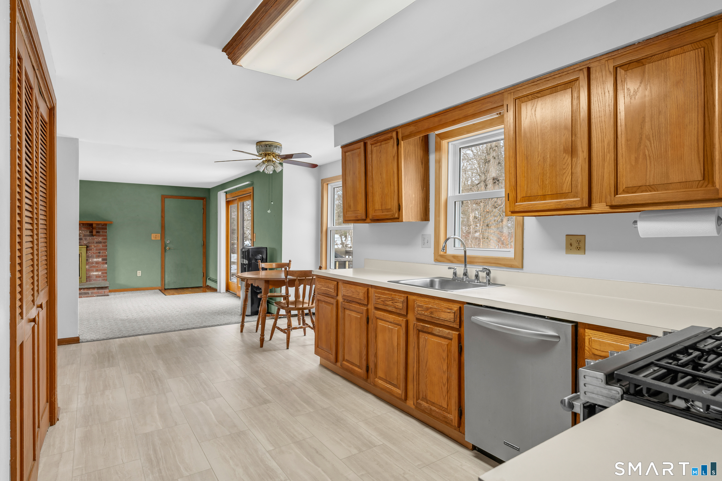 26 Pent Road Branford, CT 06405 - Photo 8 of 28 a kitchen with stainless steel appliances granite countertop a sink dishwasher stove and cabinets with wooden floor