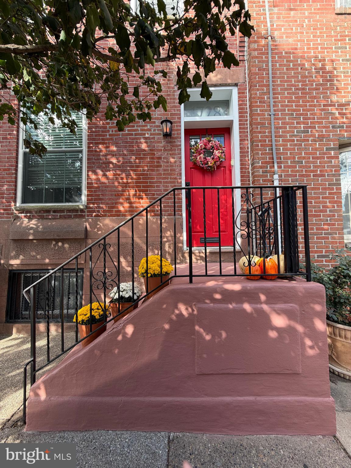 a view of building with large windows and potted plants