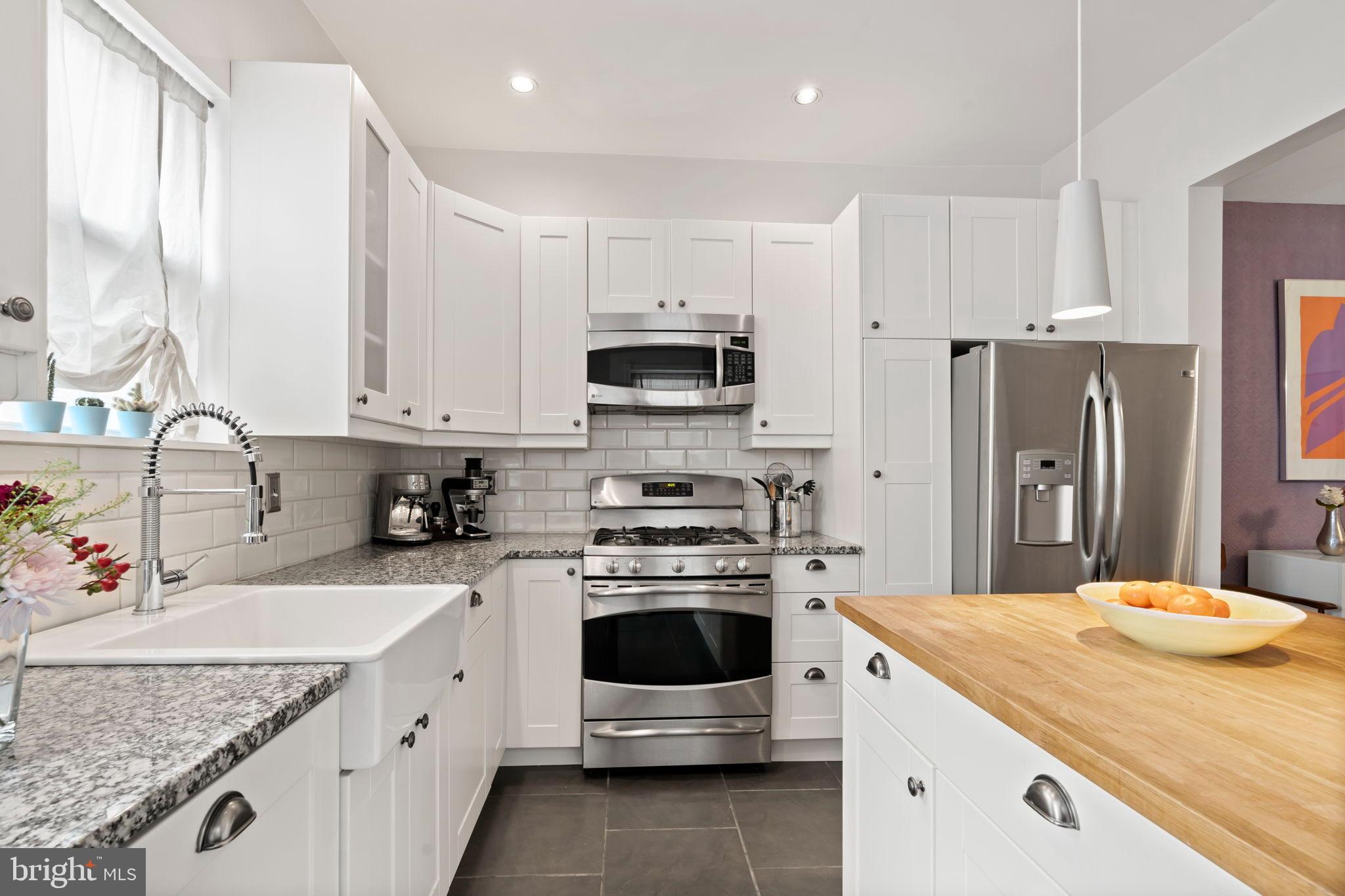 1728 South 13th Street Philadelphia, PA 19148 - Photo 16 of 31 a kitchen with stainless steel appliances a stove sink microwave and cabinets