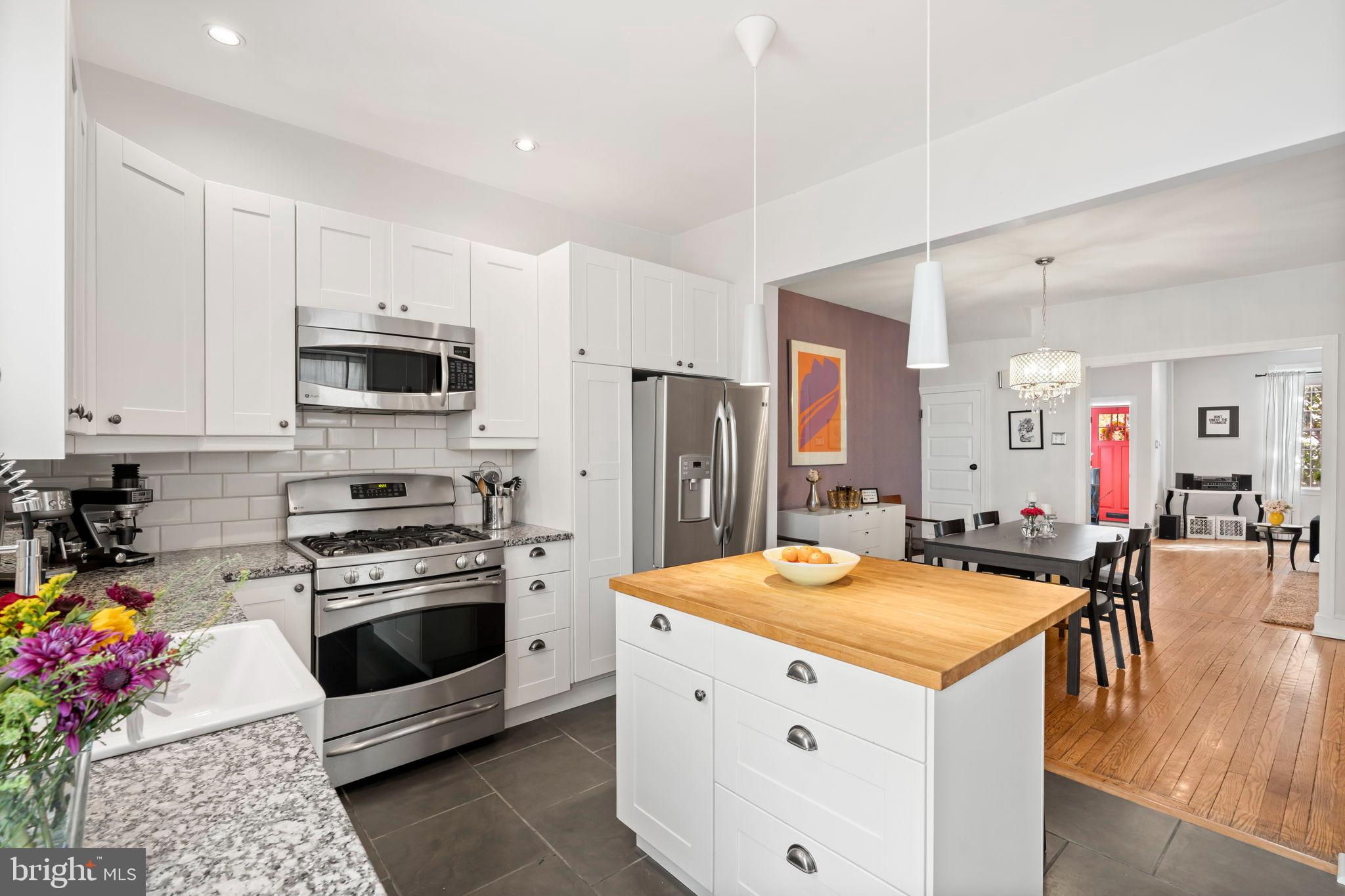 1728 South 13th Street Philadelphia, PA 19148 - Photo 17 of 31 a kitchen that has a lot of white cabinets and stainless steel appliances