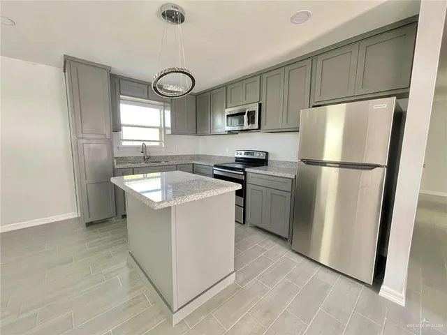 a kitchen with a sink a refrigerator a washer and dryer