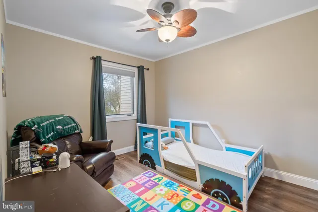 a bedroom with furniture and a window