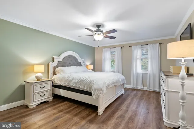 a spacious bedroom with a bed and a chandelier