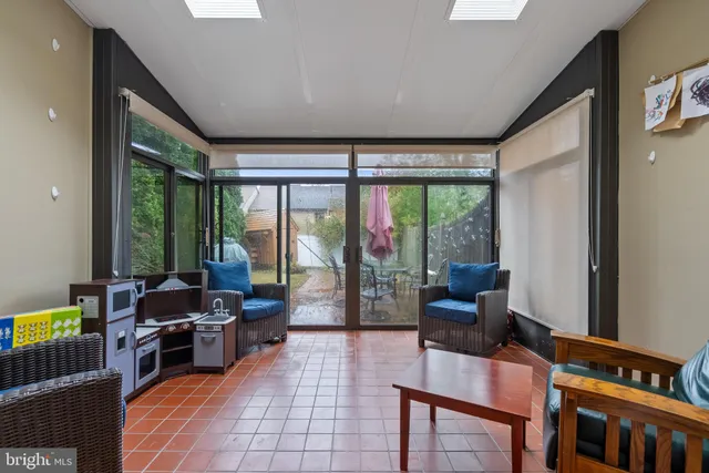 a living room with furniture and large windows