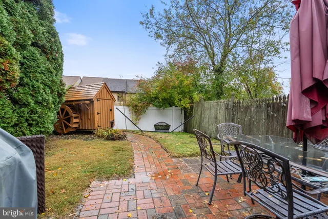 a view of a chair and table in backyard