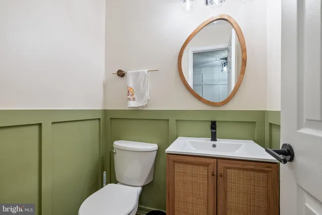 a bathroom with a toilet sink and mirror