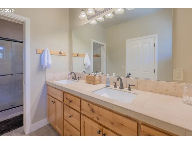 a bathroom with a sink double vanity and a mirror