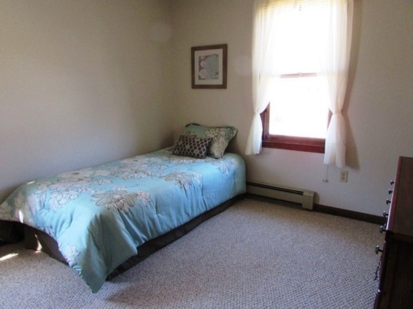 9 Sycamore Drive Rutland, MA 01543 - Photo 11 of 20 a bed sitting in a bedroom next to a window