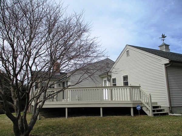 9 Sycamore Drive Rutland, MA 01543 - Photo 15 of 20 a view of a house with a deck and a yard