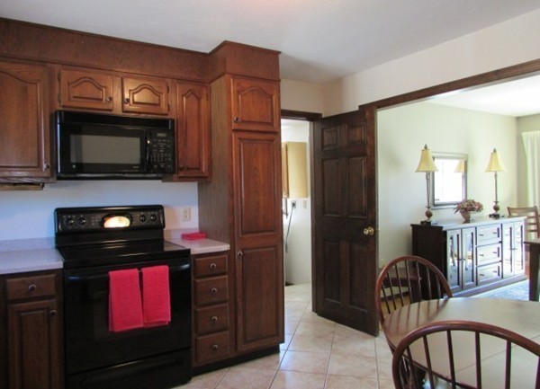 9 Sycamore Drive Rutland, MA 01543 - Photo 6 of 20 a kitchen with granite countertop a stove and a microwave