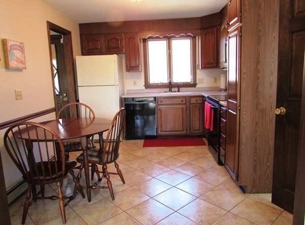 9 Sycamore Drive Rutland, MA 01543 - Photo 8 of 20 a kitchen with a dining table and chairs