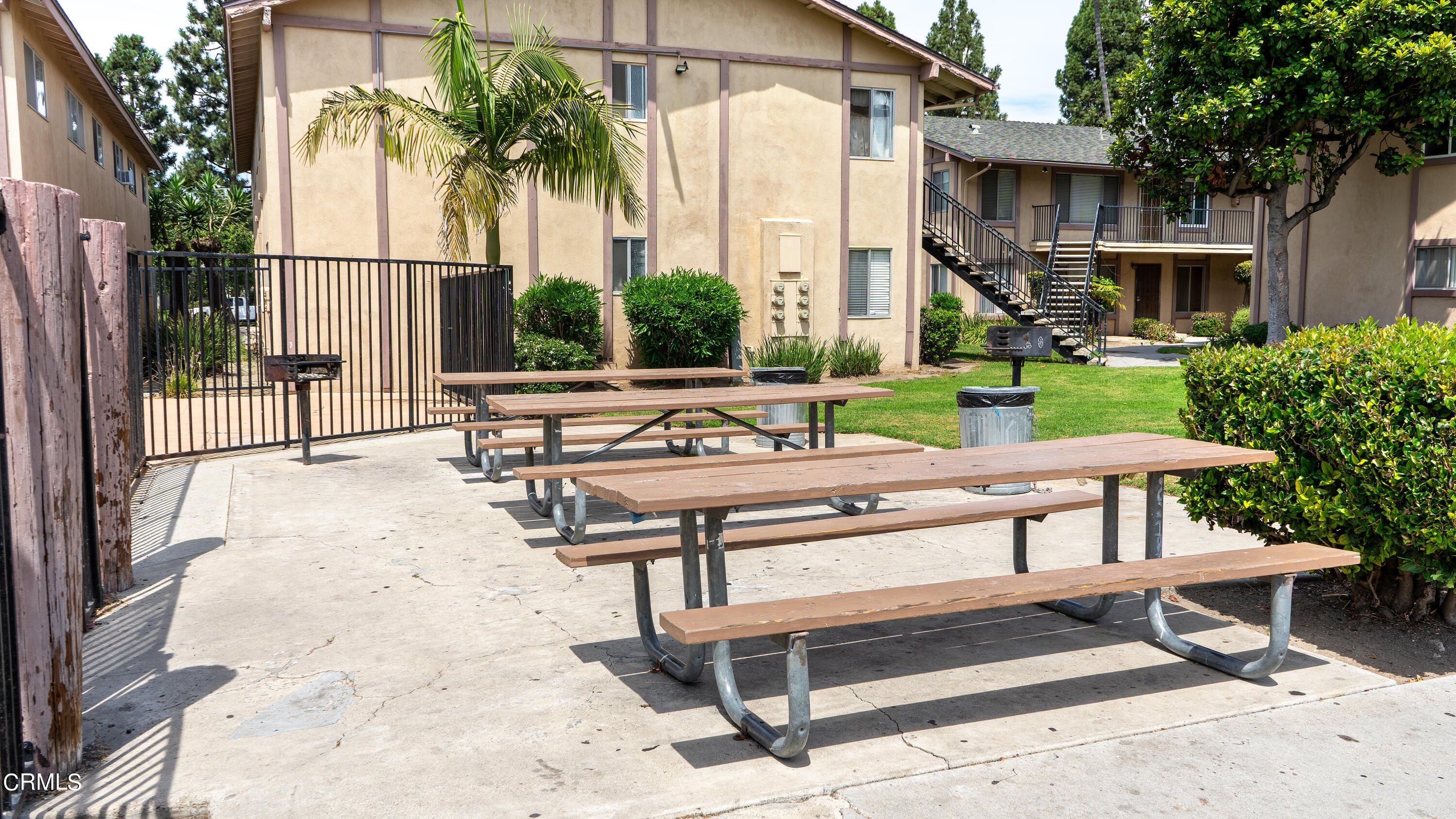 1920 North H Street, Unit 235 Oxnard, CA 93036 - Photo 11 of 13 a view of a terrace with chairs and wooden fence
