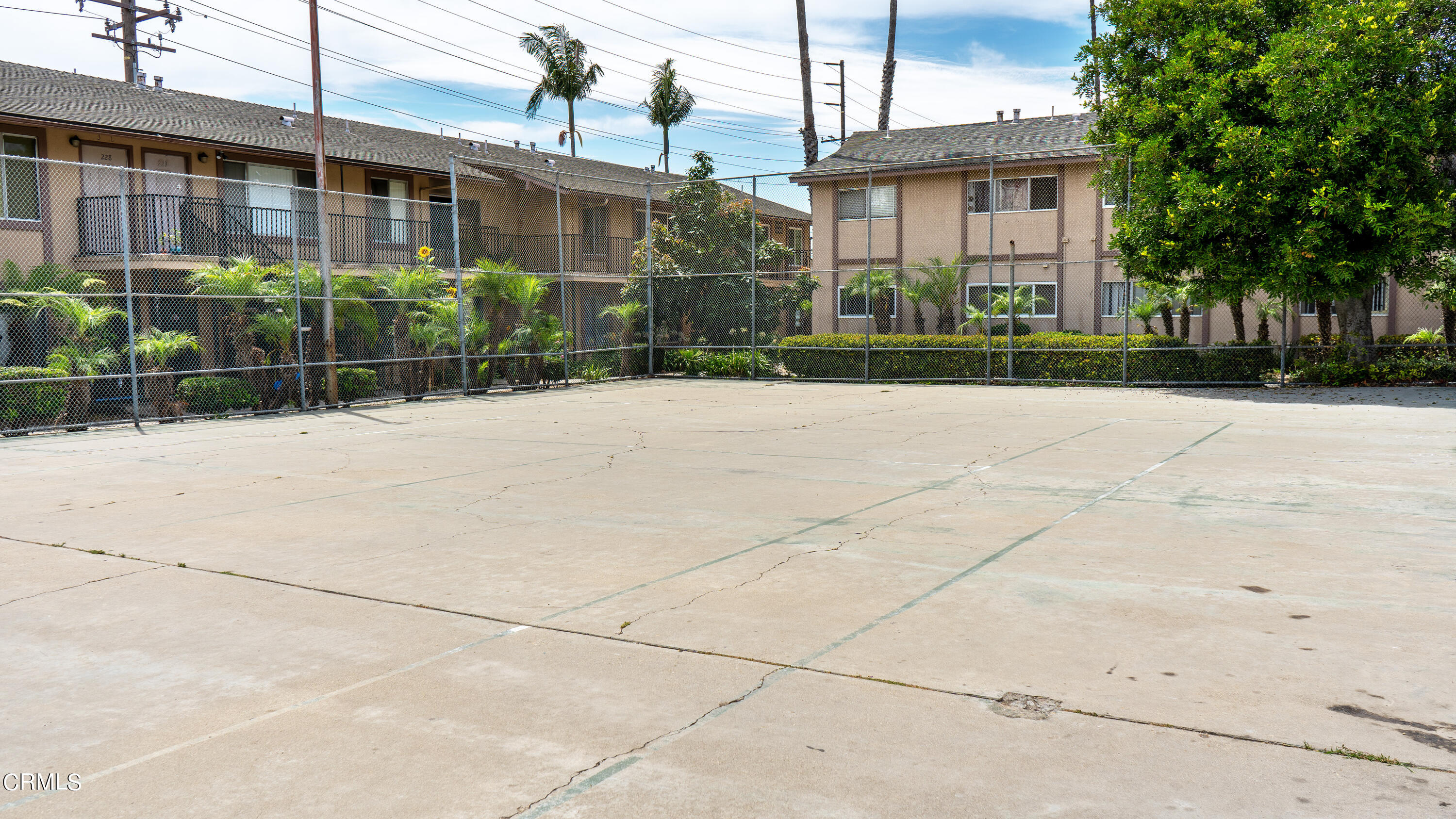 1920 North H Street, Unit 235 Oxnard, CA 93036 - Photo 12 of 13 a view of a brick house with plants and large trees