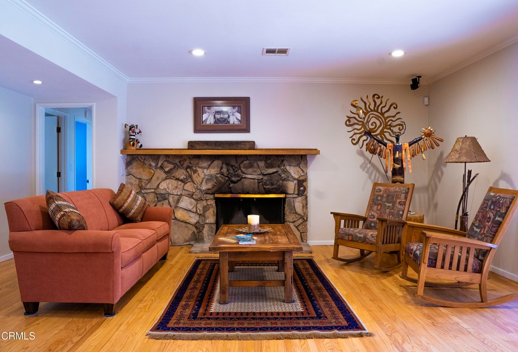 4155 Aralia Road Altadena, CA 91001 - Photo 3 of 28 a living room with furniture fireplace and wooden floor