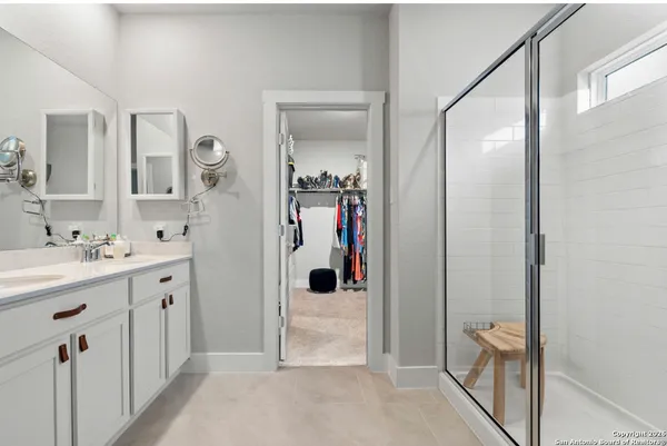 a bathroom with a shower sink and mirror