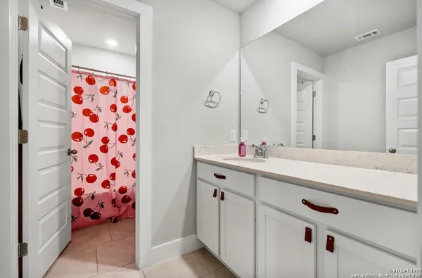 a spacious bathroom with a sink double vanity and a shower