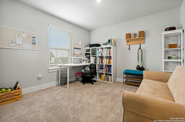a bedroom with furniture and a book shelf