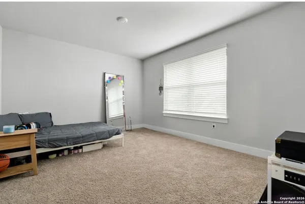 a living room with furniture gym equipment and a window