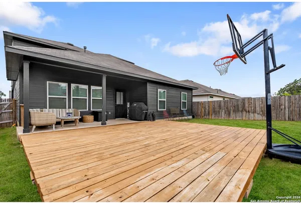 a view of a house with backyard and sitting area