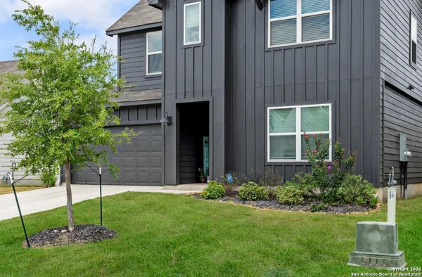 a view of a house with a yard and plants