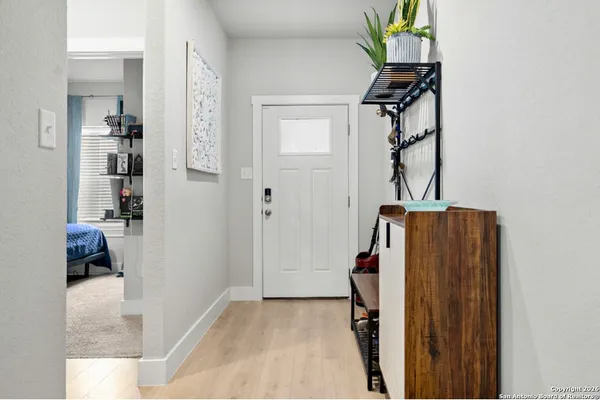 a view of hallway with wooden floor and furniture