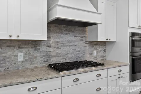 a kitchen with stainless steel appliances a sink stove and cabinets