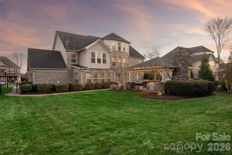 a front view of a house with a yard and trees