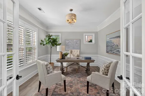 a view of a livingroom with furniture and a potted plant