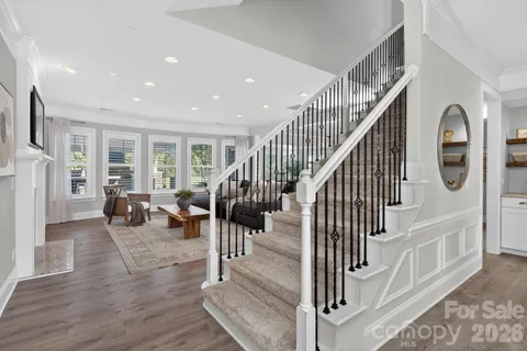 a view of entryway and hall with wooden floor