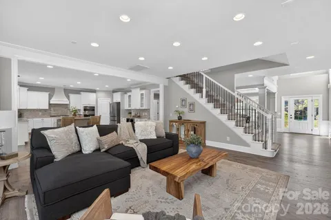 a living room with furniture and stairs