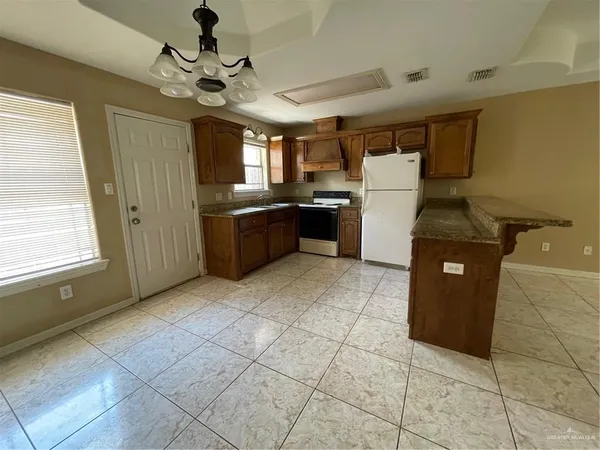 a kitchen with a stove a refrigerator and a sink