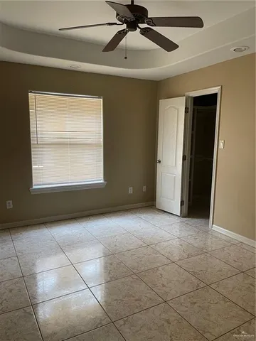 a bathroom with a granite countertop sink a toilet mirror and vanity