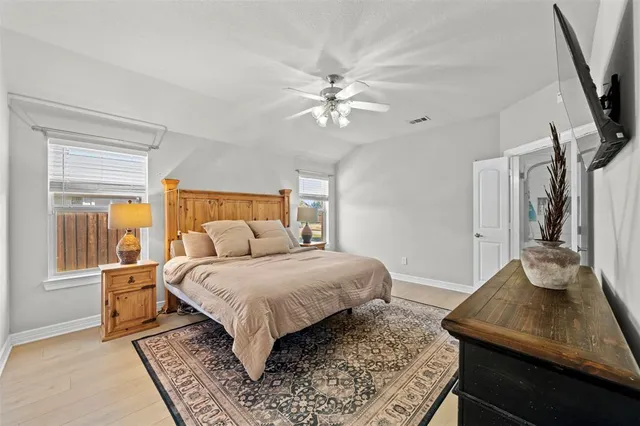 a bedroom with a bed and a flat screen tv