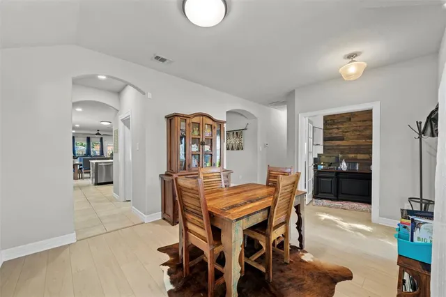 a view of a dining room with furniture and a window