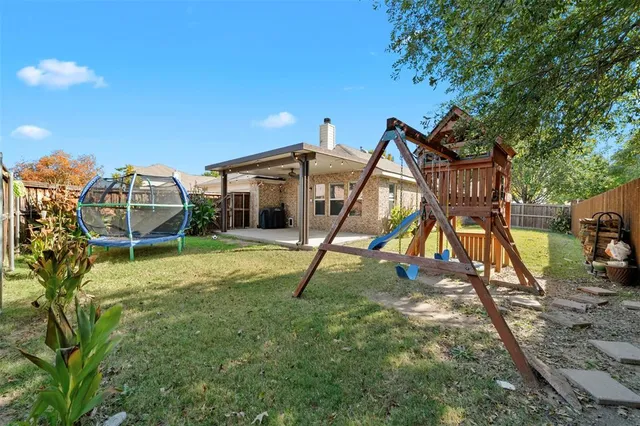 a backyard of a house with table and chairs