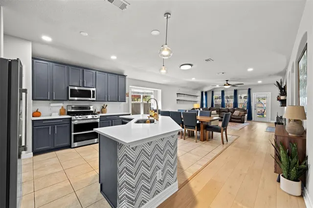 a kitchen with lots of counter top space appliances and a center island