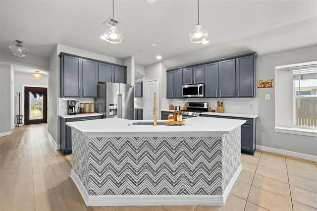 a kitchen with a sink and cabinets