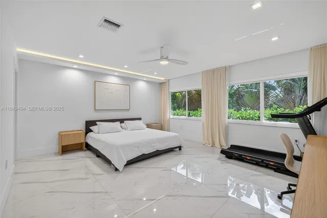 a room with a bed and a large window