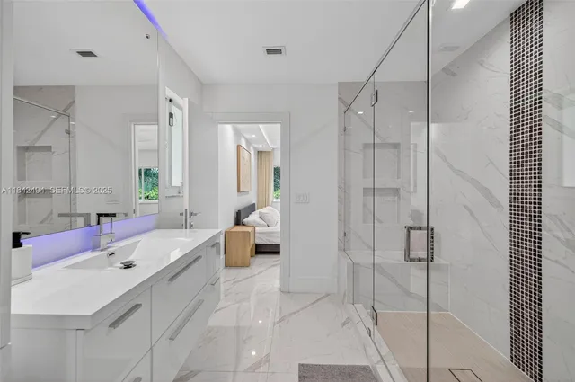 a bathroom with a tub sink shower and mirror