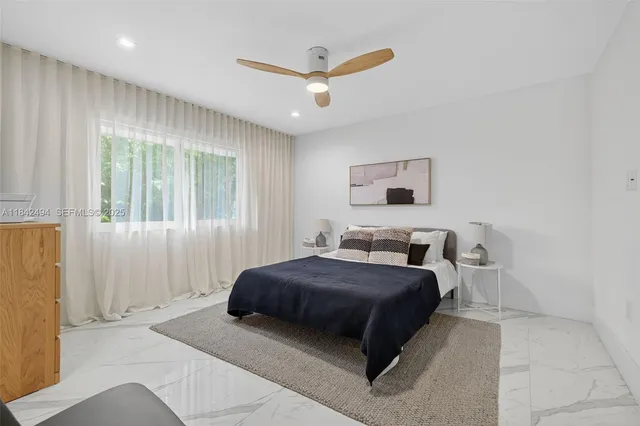 a bedroom with a bed and window