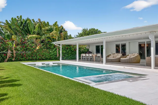 a view of a patio with swimming pool table and chairs
