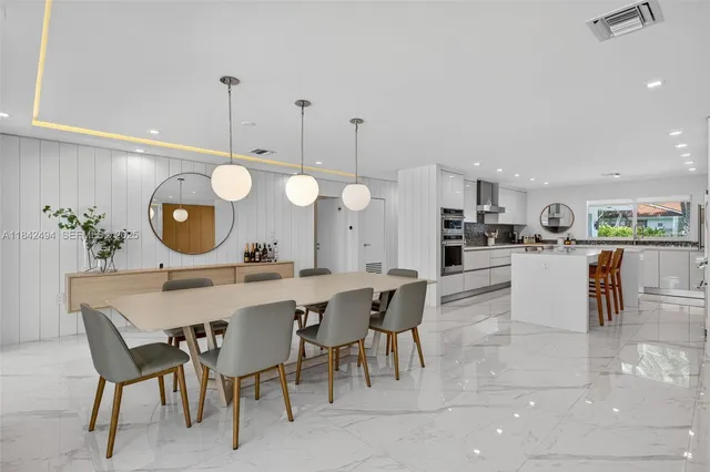 a large kitchen with a table and chairs