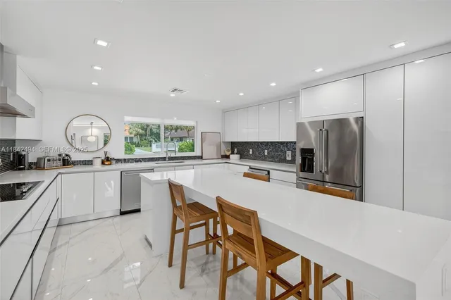 a kitchen with refrigerator and cabinets